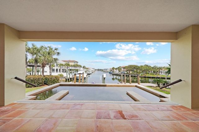 view of pool featuring a dock and a water view