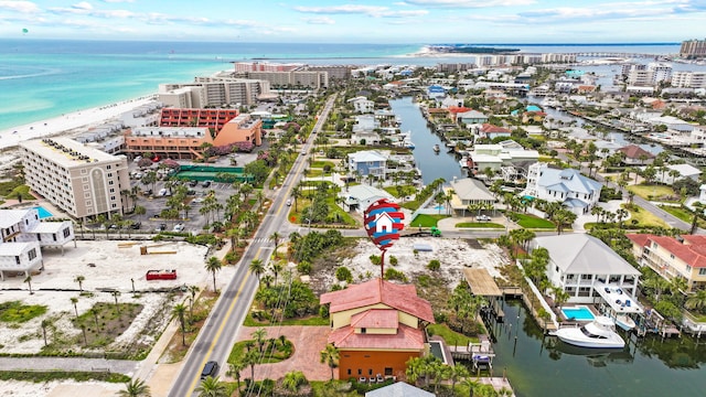 bird's eye view featuring a water view and a beach view