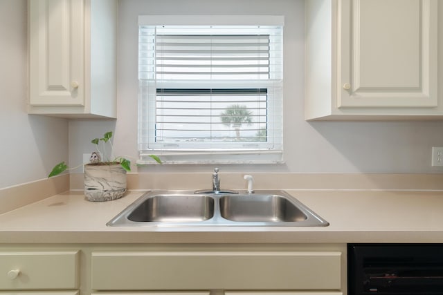 kitchen with wine cooler and sink