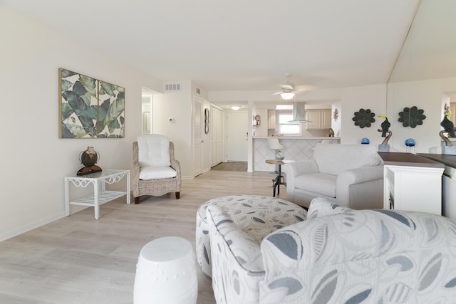 living room featuring ceiling fan and light wood-type flooring