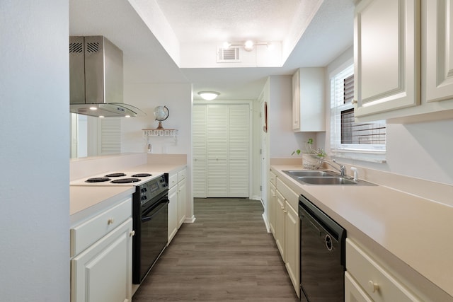 kitchen featuring white cabinetry, sink, wall chimney range hood, black appliances, and light wood-type flooring