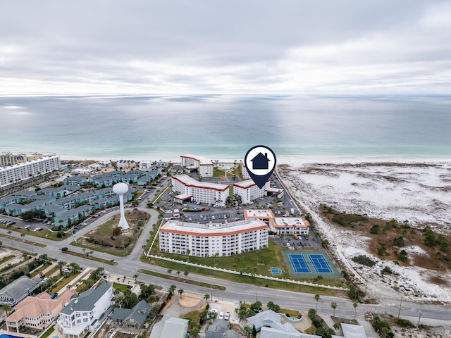 drone / aerial view with a water view and a beach view