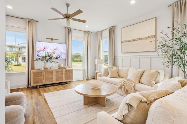 living area featuring light hardwood / wood-style floors, plenty of natural light, and ceiling fan