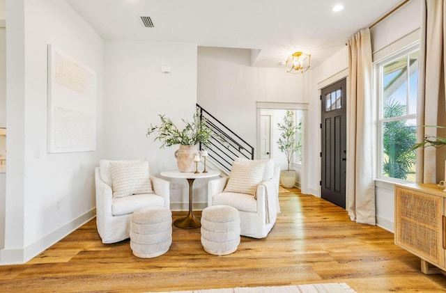 foyer with a chandelier and light wood-type flooring