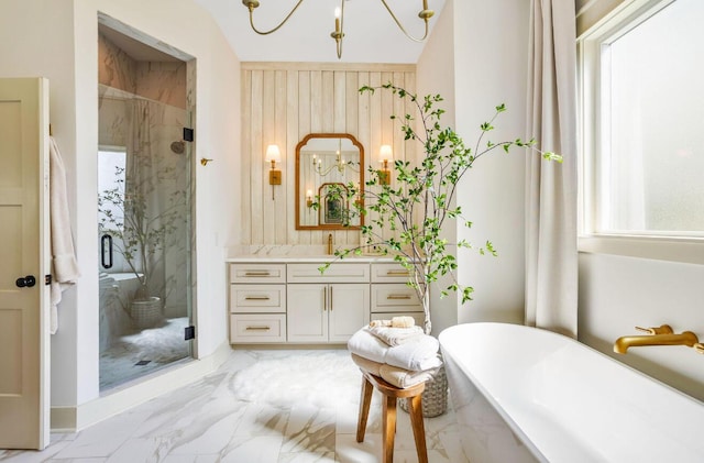 bathroom with vanity, separate shower and tub, and an inviting chandelier