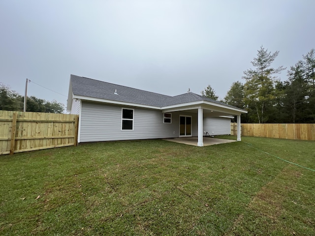 back of property with a patio and a yard