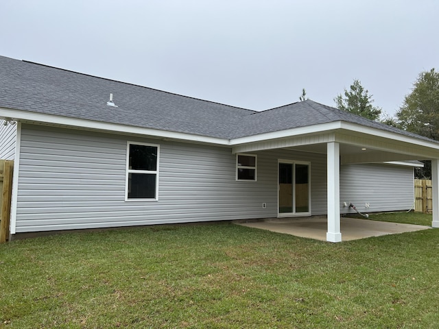 rear view of property featuring a patio area and a lawn