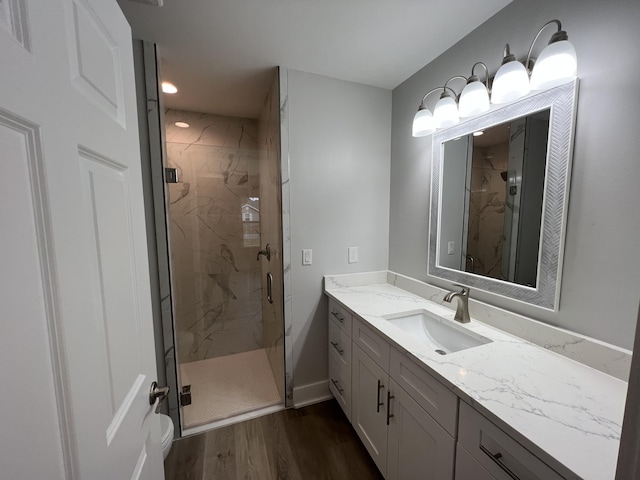 bathroom featuring vanity, walk in shower, toilet, and hardwood / wood-style flooring