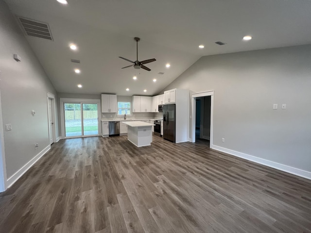 kitchen featuring hardwood / wood-style flooring, a center island, white cabinets, appliances with stainless steel finishes, and ceiling fan