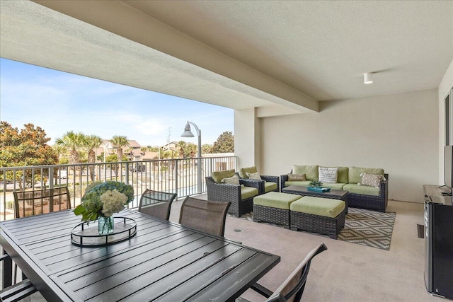 view of patio featuring a balcony and an outdoor hangout area