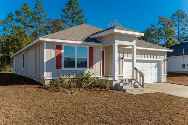 view of front of property with a front yard and a garage