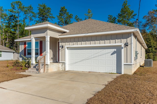 view of front of house with central AC and a garage