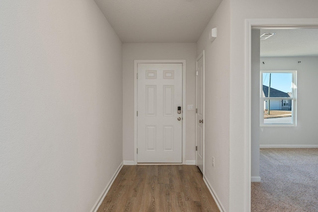 corridor with hardwood / wood-style floors