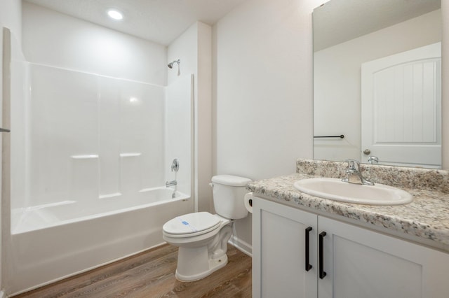 full bathroom featuring vanity, toilet, wood-type flooring, and tub / shower combination