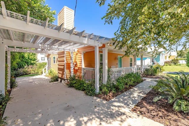 view of patio / terrace with a porch and a pergola