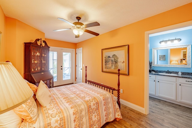 bedroom with access to exterior, french doors, ceiling fan, sink, and light hardwood / wood-style floors