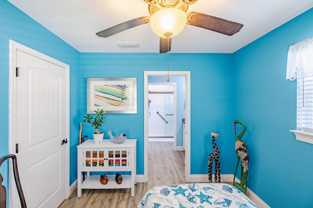 bedroom with ceiling fan and light hardwood / wood-style floors