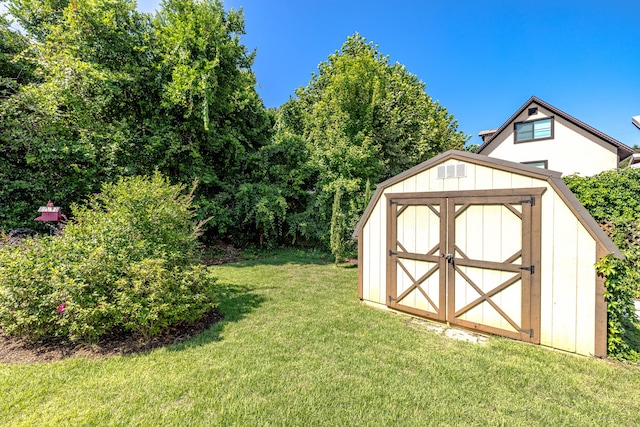 view of outbuilding with a yard