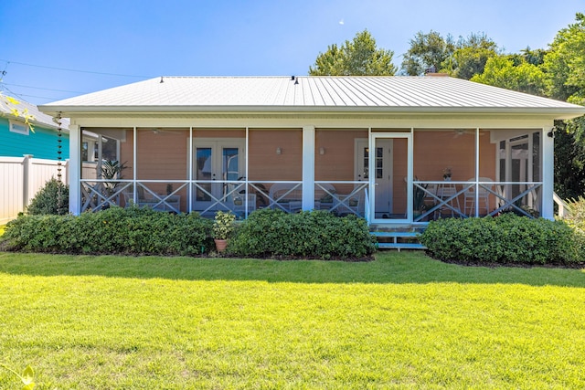 rear view of house featuring a yard and french doors