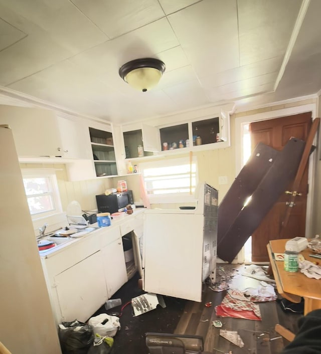 kitchen featuring open shelves, washer / clothes dryer, light countertops, and white cabinetry