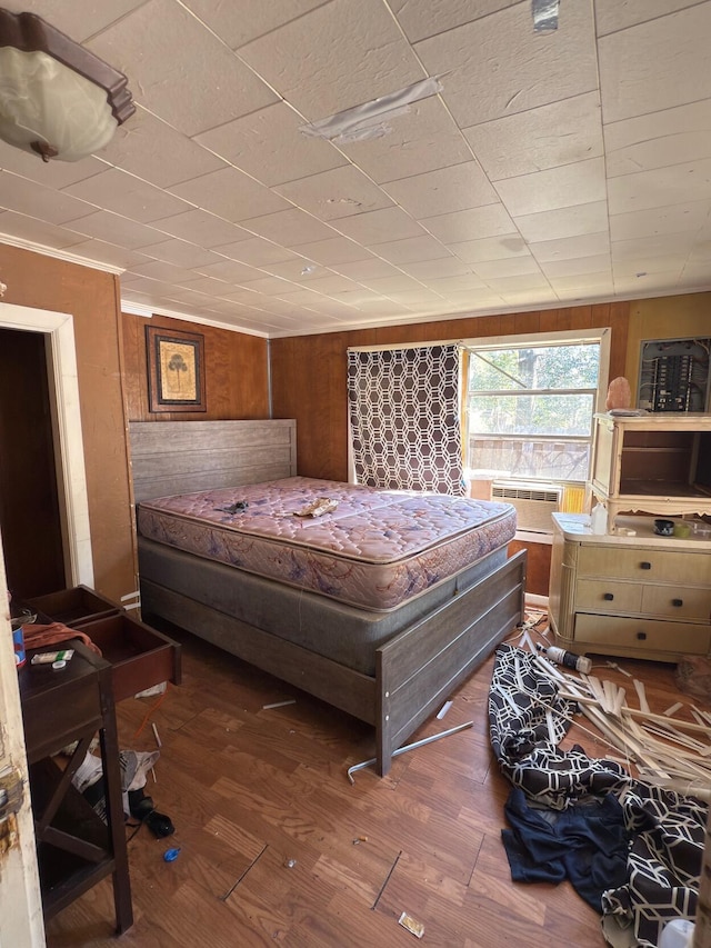 bedroom with wooden walls and wood finished floors