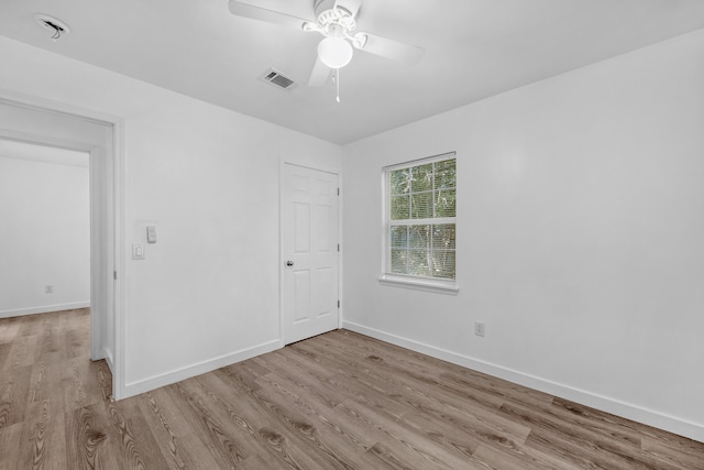 unfurnished room with light wood-type flooring and ceiling fan