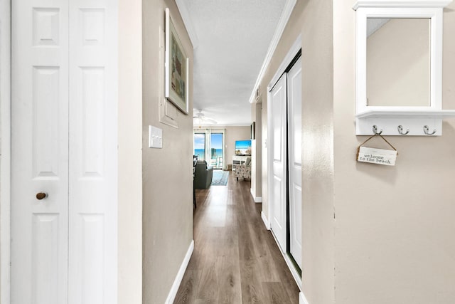 hall featuring crown molding and wood-type flooring