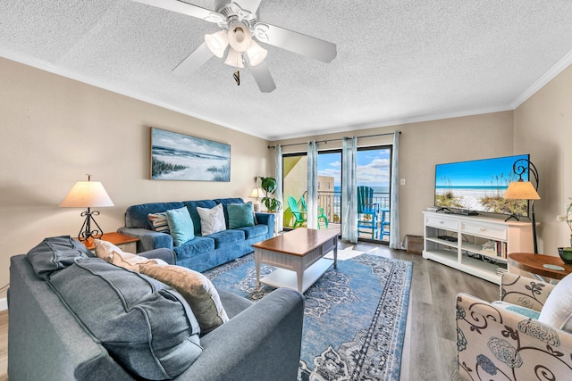 living room featuring hardwood / wood-style floors, ceiling fan, crown molding, and a textured ceiling