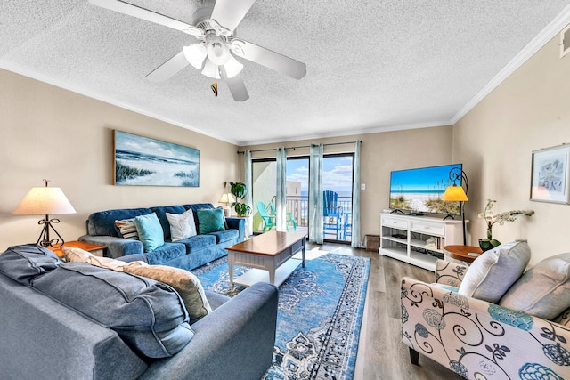 living room featuring a textured ceiling, ceiling fan, wood-type flooring, and crown molding