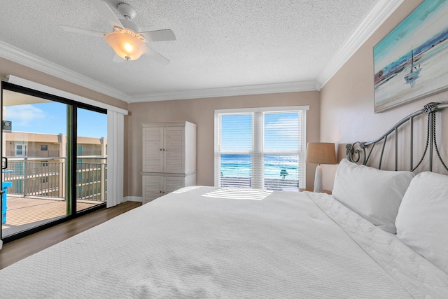 bedroom featuring ornamental molding, a textured ceiling, access to outside, ceiling fan, and a water view