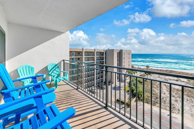 balcony with a water view and a beach view