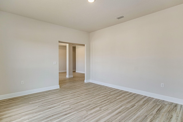 unfurnished room with light hardwood / wood-style flooring