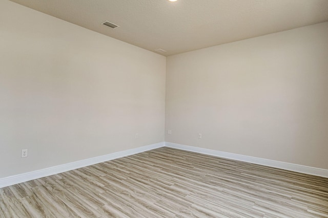 unfurnished room with light hardwood / wood-style floors