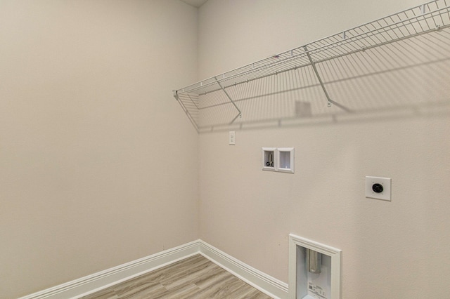 washroom with hookup for an electric dryer, washer hookup, and hardwood / wood-style floors