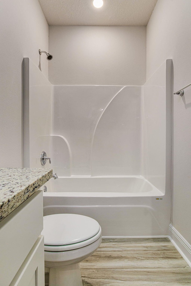 full bathroom with a textured ceiling, vanity, toilet, and tub / shower combination