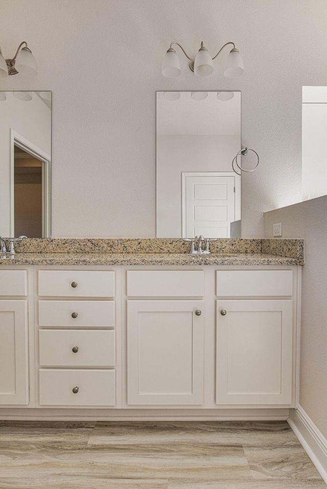 bathroom with vanity and hardwood / wood-style flooring