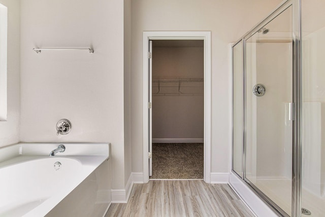 bathroom with plus walk in shower and hardwood / wood-style floors