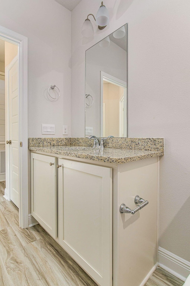 bathroom with vanity and hardwood / wood-style flooring