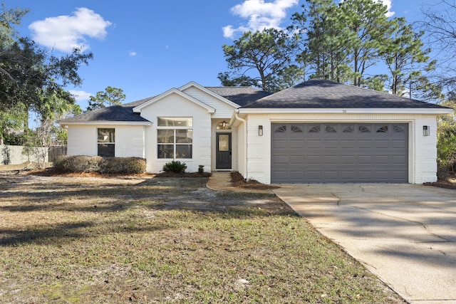 ranch-style house featuring a garage and a front lawn