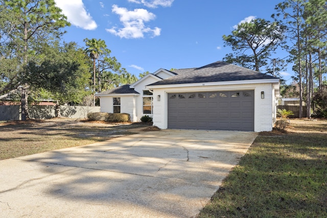 ranch-style house featuring a garage and a front lawn