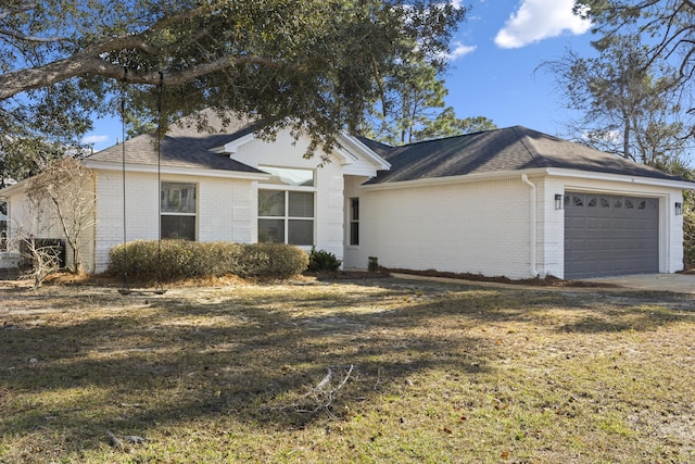 single story home featuring a garage and a front yard