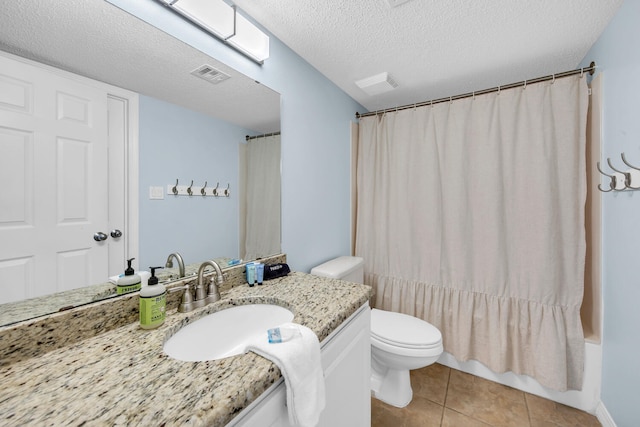376 Santa Rosa Boulevard Unit 112 - 2Nd Floor, Fort Walton Beach, FL 32548 - full bathroom with vanity, tile patterned flooring, toilet, shower / bath combo with shower curtain, and a textured ceiling