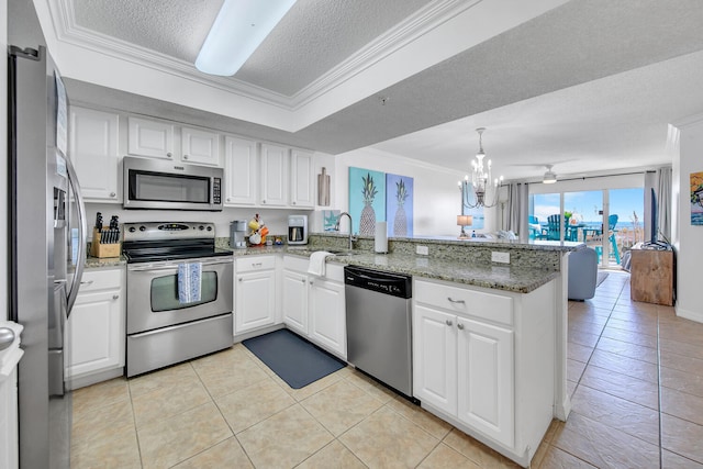 376 Santa Rosa Boulevard Unit 112 - 2Nd Floor, Fort Walton Beach, FL 32548 - kitchen with kitchen peninsula, a chandelier, a textured ceiling, white cabinets, and appliances with stainless steel finishes
