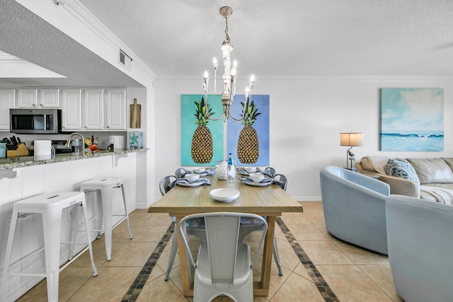 376 Santa Rosa Boulevard Unit 112 - 2Nd Floor, Fort Walton Beach, FL 32548 - tiled dining area with a chandelier, a textured ceiling, and ornamental molding