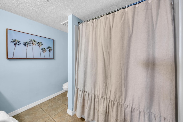 376 Santa Rosa Boulevard Unit 112 - 2Nd Floor, Fort Walton Beach, FL 32548 - bathroom featuring tile patterned flooring, a textured ceiling, and toilet