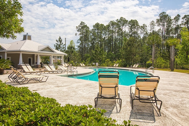 view of swimming pool featuring a patio area