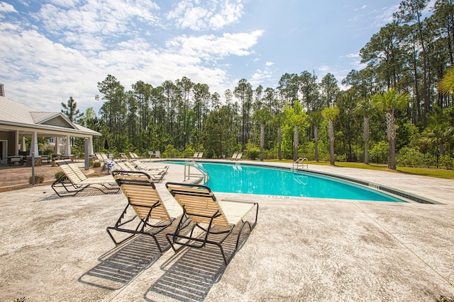 view of swimming pool featuring a patio