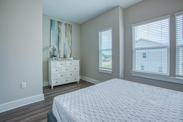 bedroom with dark wood-type flooring