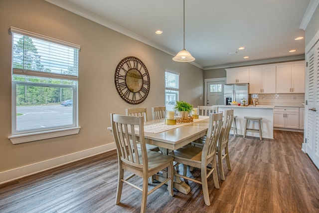 dining space featuring a healthy amount of sunlight, crown molding, and dark wood-type flooring