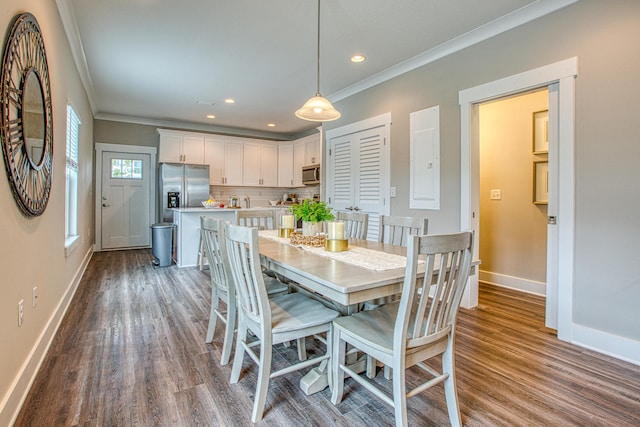 dining space featuring ornamental molding and hardwood / wood-style flooring